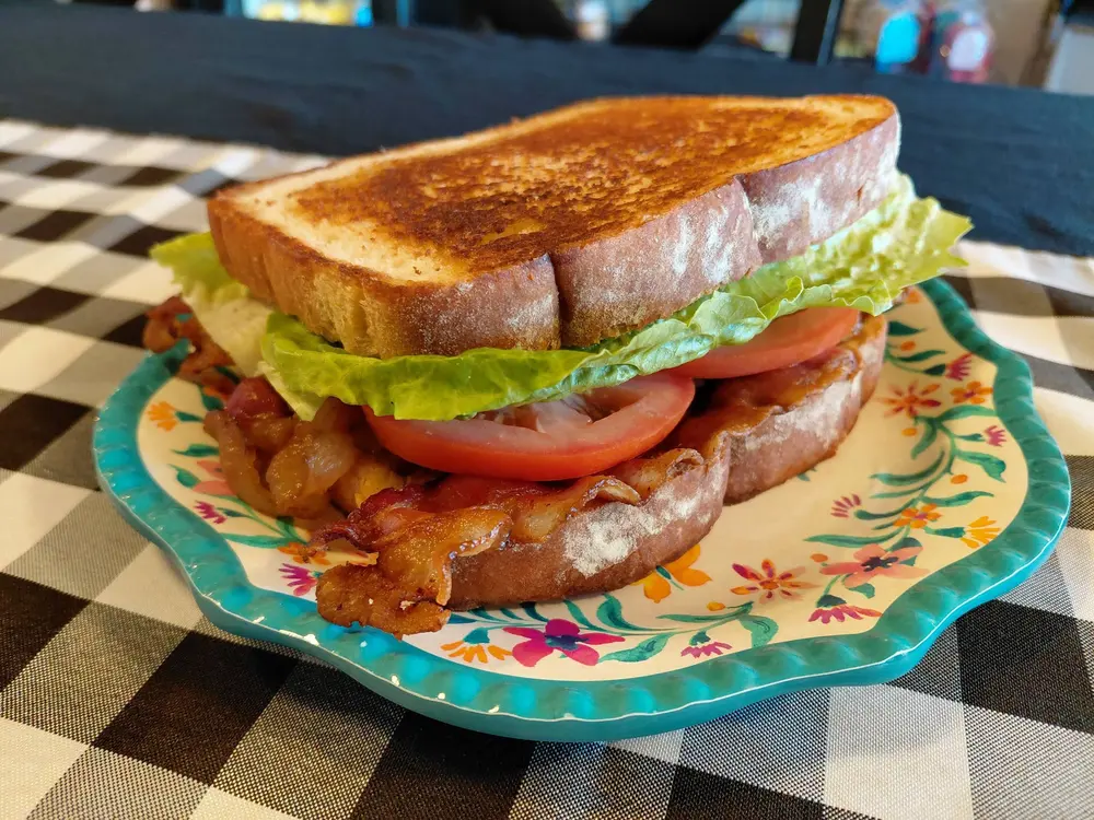 A thick BLT sandwich with crisp bacon, lettuce and tomato on toasted bread