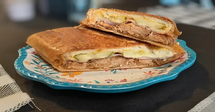 A pressed Cuban sandwich sliced in half