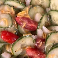 Cucumber salad with tomatoes and onion in a vinegar dressing